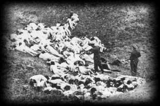 SS man shooting a wounded woman who is trying to get up.